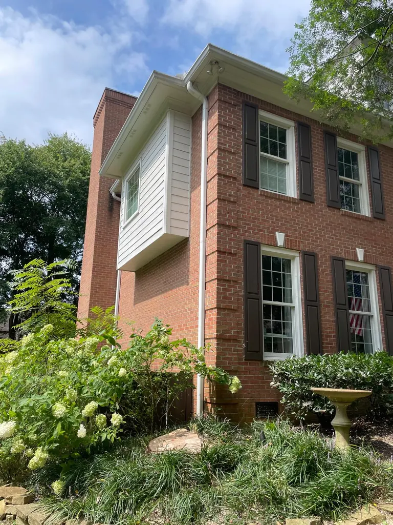 Finished brick home with hydrangeas after tree work in Knoxville, Tennessee