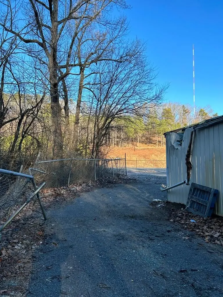 Gravel drive and metal shed on a property cleared of trees near Knoxville, TN